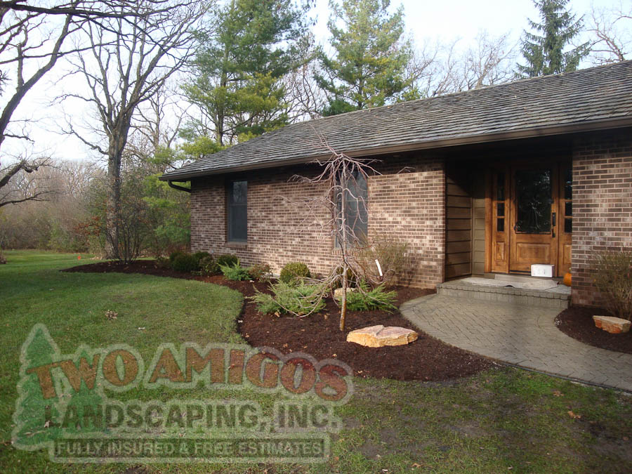 Bed cleanup, edging, mulching, planting and rock installation